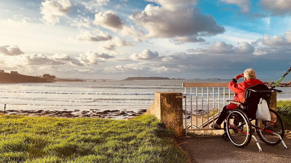 A wheelchair user looking out across the coastline